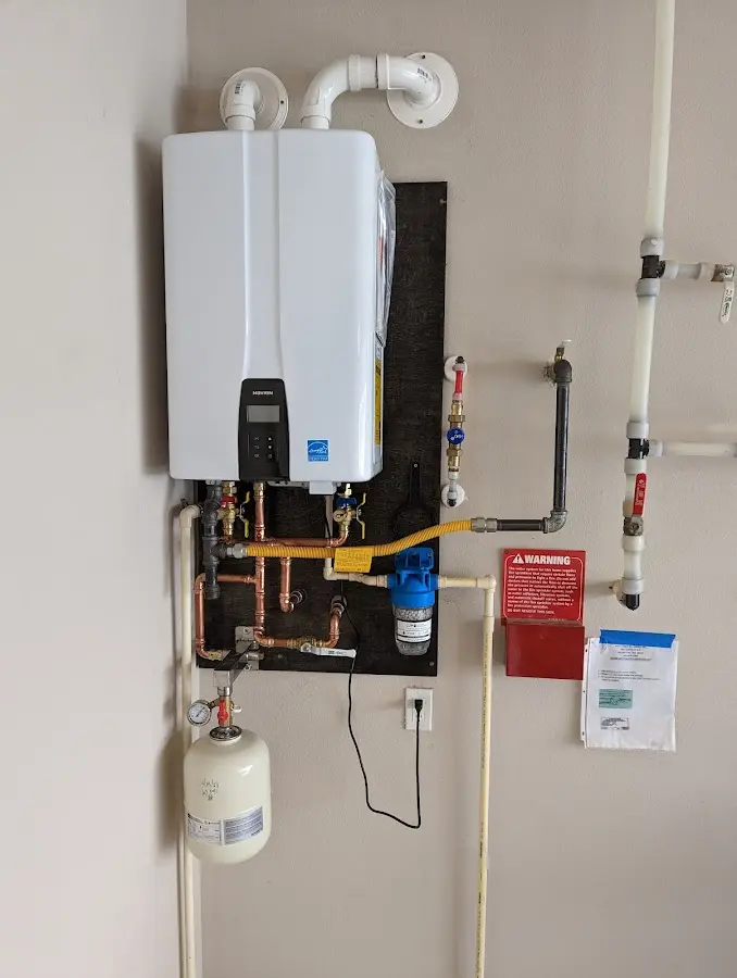 Professional plumber installing copper piping in a Farmington home